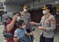Kapolres Karimun Yunita Stevani membagikan masker dan mengatur lalu lintas, lalu mengedukasi pelajar SMPN 1 Karimun tentang bullying dan narkoba.